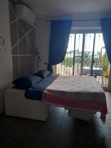 a bedroom with a bed and a window with a view at A Santy's House 1piano-no lift-raggiungibile a piedi aeroporto-fermata bus fiera di roma a 3 minuti-NO ANIMALI bed FOR A FEE A PAGAMENTO in Fiumicino