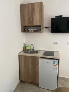 una piccola cucina con lavandino e frigorifero di Apartments Gusar a Ulcinj