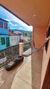 a balcony with a hammock and a view at Covil das Trilhas Hostel in Lençóis