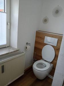 a bathroom with a white toilet and a window at Ferienwohnung Allgäu 3 in Memmingen +30 photos