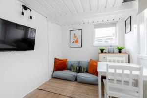 a living room with a couch and a table at Charming Primrose Hill Loft near train station in London