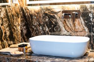 a bathroom with a white sink on a counter at FLOARA DI MUNTE Forest Luxury Suites in Metsovo