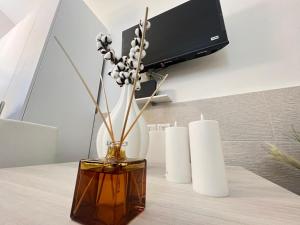 a vase with flowers in it sitting on a table at MACA HOUSE in Bari +6 photos