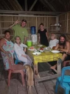 a group of people sitting around a table with a dog at Amfriwen Homestay in Yennanas Besir