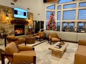 a living room with a christmas tree and a fireplace at The Hideout Golf Club & Resort in Lake Brownwood
