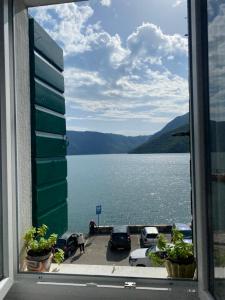 a view of a large body of water from a window at Vendetta Montenegro in Risan +3 photos