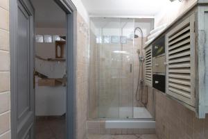 a bathroom with a shower with a glass door at TonyHouse in Casal Palocco