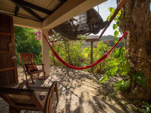 a porch with a red rope on a house at 1 bedroom apartment with bay view, 3 blocks from beach and center of San Juan in San Juan del Sur