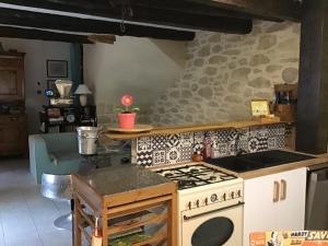 a kitchen with a stove and a counter top at La maison d’Irma in Claira