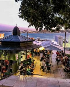 Un groupe de personnes assises à une table avec des parapluies dans l'établissement BestHomeStay-Lisbon (Campolide), à Lisbonne