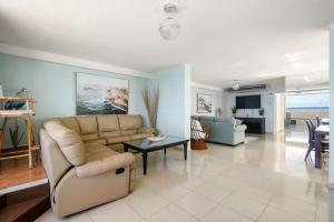 a living room with a couch and a table at Oceanfront Paradise - Spacious and Family Friendly in San Juan