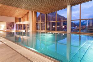 a large swimming pool in a building with windows at SPA Hotel Erzherzog Johann in Bad Aussee