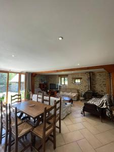 a living room with a wooden table and chairs at Chez Baptistète in Labastide