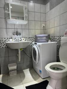 a bathroom with a washing machine and a sink at Apartment Tena in Senj +26 photos