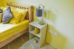 a bedroom with a bed and a lamp on a night stand at Pierocks Highgate Entire house Free Parking and WI-FI in Arnos Vale