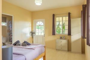 a bedroom with a bed and a window at Pierocks Highgate Entire house Free Parking and WI-FI in Arnos Vale