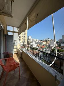 a balcony with a bench and a view of a city at Sol Central Apartament in Durrës