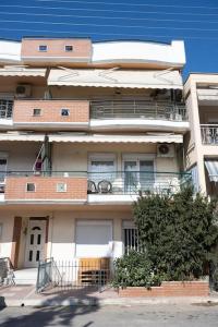an apartment building with balconies on the side of it at Spacious and comfy apartment in Nea Moudania