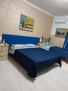 1 dormitorio con 1 cama azul y vestidor en Oasi Del Relax, en Civitavecchia