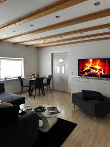 a living room with a fireplace and a table at Wohnung im Herzen von Immenstadt im Allgäu in Immenstadt im Allgäu