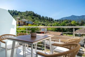 a patio with a table and chairs on a balcony at Port Oasis in Limenas