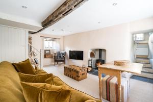 a living room with a couch and a table at Blue Cottage! Amazing views & Cosy Lux Interiors in Bodinnick