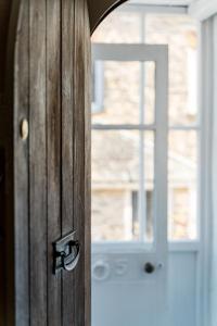 a close up of a wooden door with a window at Blue Cottage! Amazing views & Cosy Lux Interiors in Bodinnick