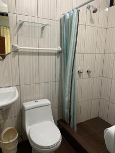 a bathroom with a toilet and a shower at Hotel sueño Tropical in Tarapoto