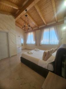 a bedroom with a large bed with two people laying on it at Golden house sicily in Catania