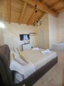 a large bed with pillows and a television in a room at Golden house sicily in Catania +32 photos