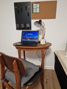 a desk with a laptop and a lamp on it at Apartman Pobednik in Belgrade