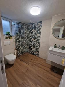 a bathroom with a shower and a toilet and a sink at Apartman Pobednik in Belgrade