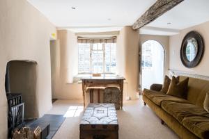 a living room with a couch and a table at Blue Cottage! Amazing views & Cosy Lux Interiors in Bodinnick