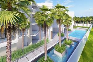 an aerial view of a building with palm trees at Penthouse Playa Encuentro/ private spa in Cabarete