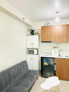 a living room with a couch and a kitchen at Condo near Airport in Lapu Lapu City