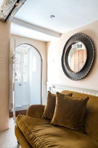 a living room with a couch and a mirror at Blue Cottage! Amazing views & Cosy Lux Interiors in Bodinnick