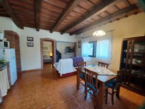 a living room with a table and a bedroom at CAN PLANAS Rural in Parlavà