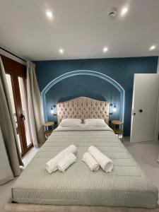 a bedroom with a large bed with two towels on it at Incanto Luxury Suites in Nafpaktos