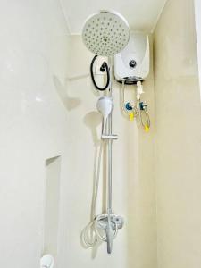 a bathroom with a shower with a shower head at WV 8 Serene Family Room in Iloilo City