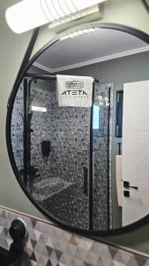 a mirror reflection of a shower in a bathroom at ATETA Tiny House 