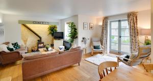 a living room with a couch and a fireplace at Toad Hall Lake Access & Pet Friendly in Somerford Keynes
