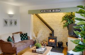 a living room with a couch and a wood stove at Toad Hall Lake Access & Pet Friendly in Somerford Keynes +82 photos