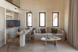 a living room with a couch and a table at Montesea - Luxury Nature Villas in Vasilikos