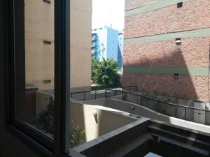 Blick auf einen Balkon aus dem Fenster in der Unterkunft Nuñez apartment for 4 with near Aeroparque in Buenos Aires
