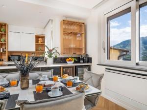 a kitchen with a table and chairs and a window at De Vivo Realty - Regina Vittoria Relais EcoSmart Luxury Home SPA in Vico Equense