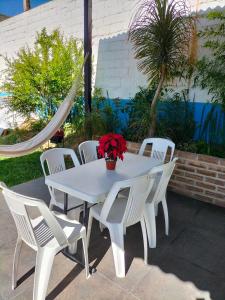 a white table and chairs with a flower pot on it at KC Hotel & Suites in Comitán