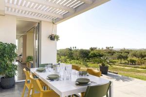 a white table and chairs on a patio at Martina's Vineyard - rooms in Marsala