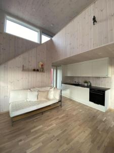 Borestranda - Nytt strandhus med 6 sengeplasser! في Klepp: غرفة معيشة مع أريكة بيضاء في غرفة