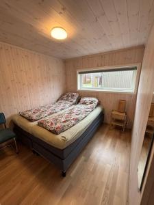 a bedroom with a bed in a room with a window at Borestranda - Nytt strandhus med 6 sengeplasser! in Klepp