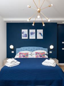 a blue bedroom with a blue bed with two pillows at Regina Vittoria Relais in Vico Equense